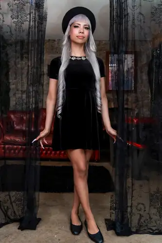 Slim TS Itzel Saenz in a black dress in the gloomy atmosphere of a sex dungeon